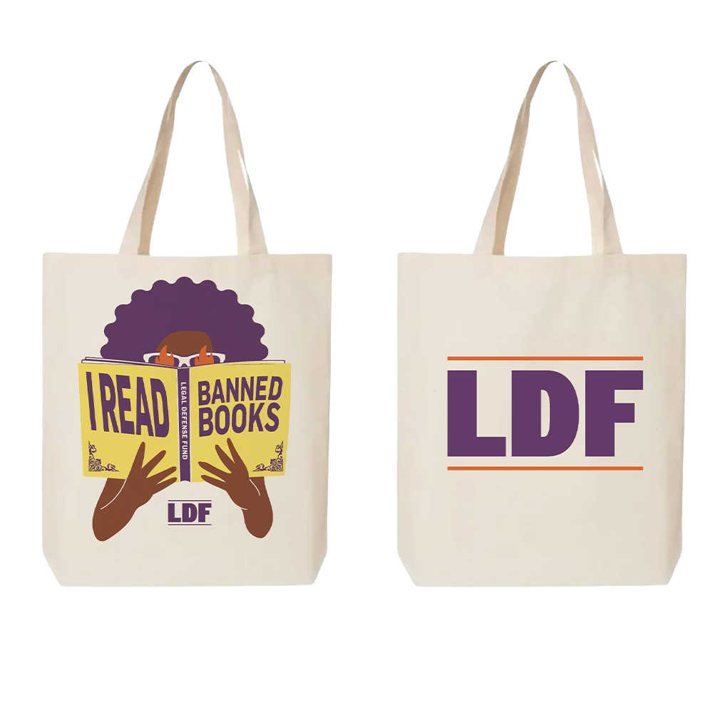 Two cream canvas tote bags shown side by side on a white background. The left bag features a graphic of a person with an afro holding a book that reads 'I READ BANNED BOOKS' with 'LDF' below, and the right bag displays 'LDF' in large purple letters with thin orange lines.